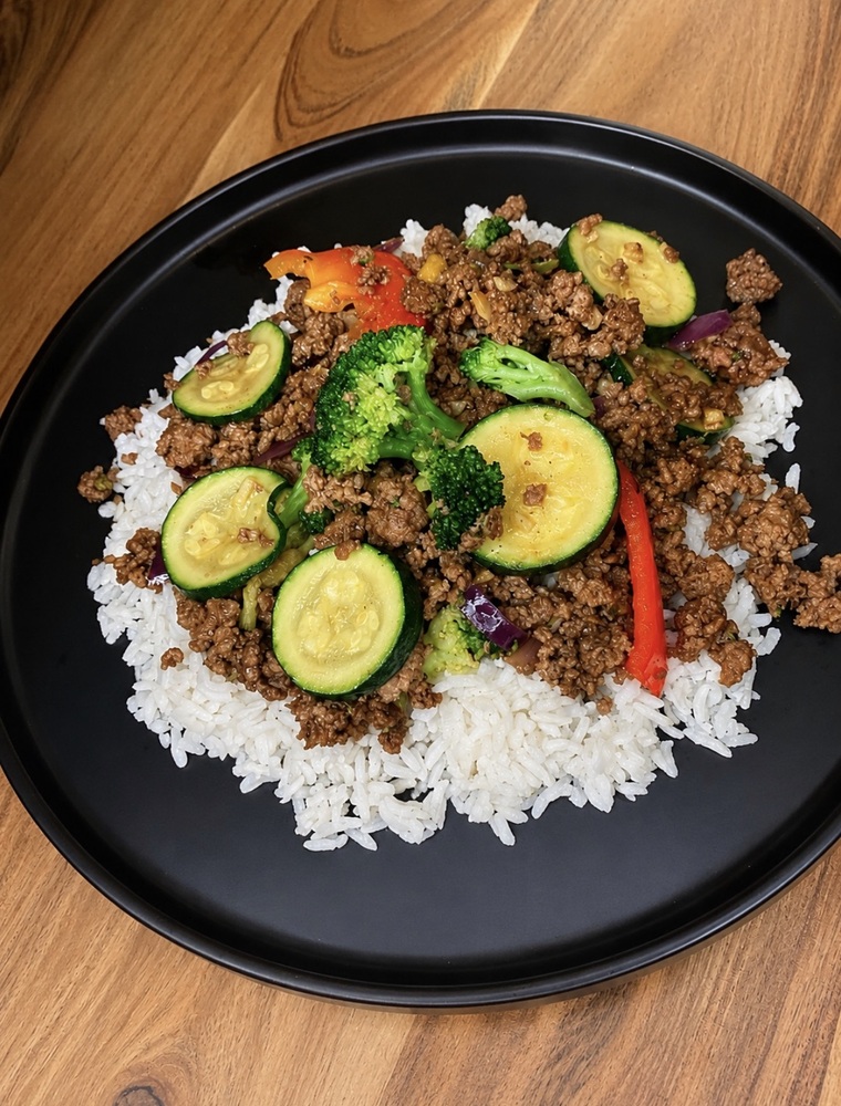 Mongolian beef bowl with ground beef, broccoli, zucchini, red pepper, and rice