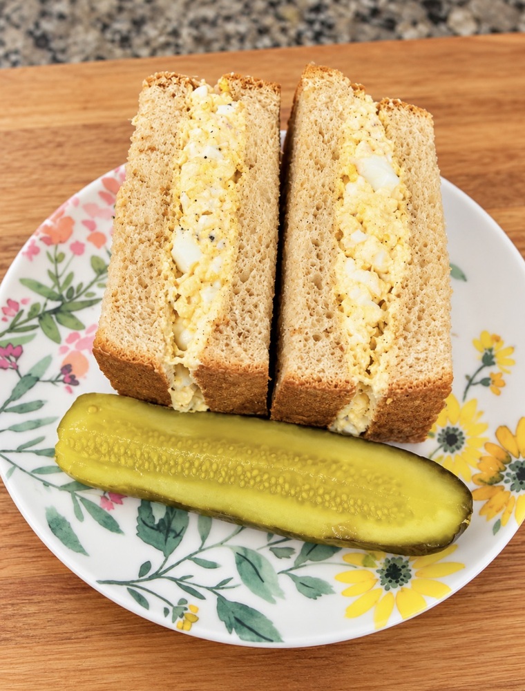 Tuna egg sandwich with creamy tuna, chopped boiled eggs, and mayonnaise served with bread.