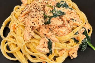 Creamy salmon pasta with miso sauce, fettuccine, and baby spinach