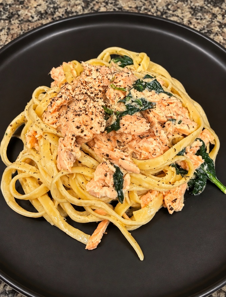 Creamy salmon pasta with miso sauce, fettuccine, and baby spinach